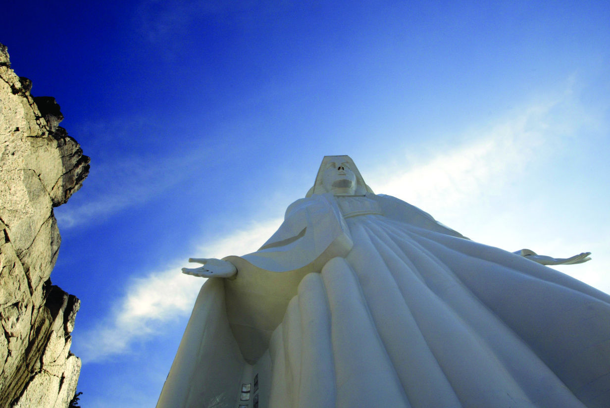 Sun shines above Our Lady of the Rockies